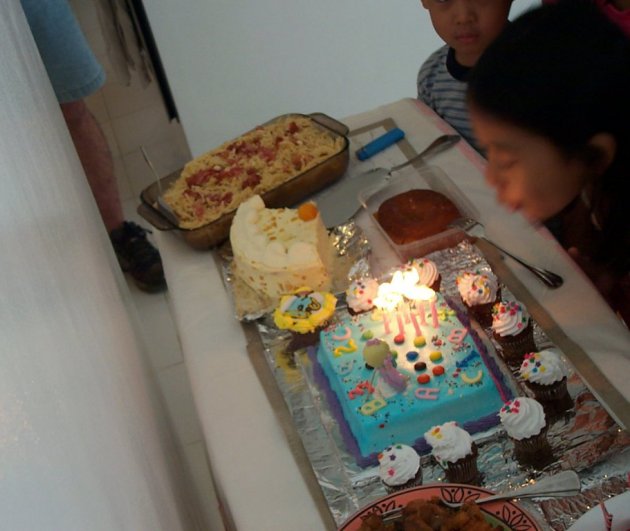 Arielle blowing birthday cake candles