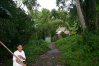 Caysasay Ruins -- Boy with bamboo pole fetches holy water from the base of the ruins for visitors to wash with